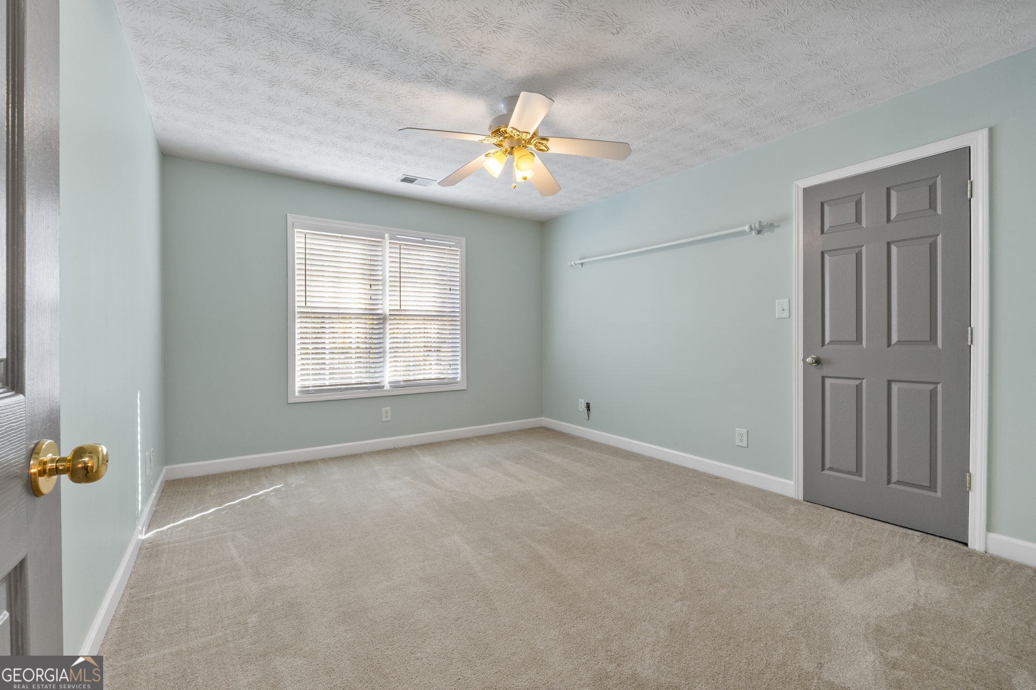400 Moseley Road Stockbridge, GA 30281 - Photo 36 of 70 an empty room with windows and chandelier fan