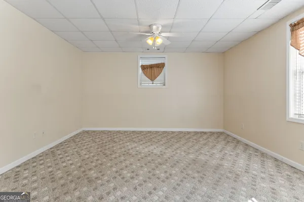 a backyard of a house with barbeque oven and trees