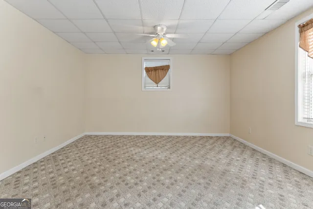 a backyard of a house with barbeque oven and trees