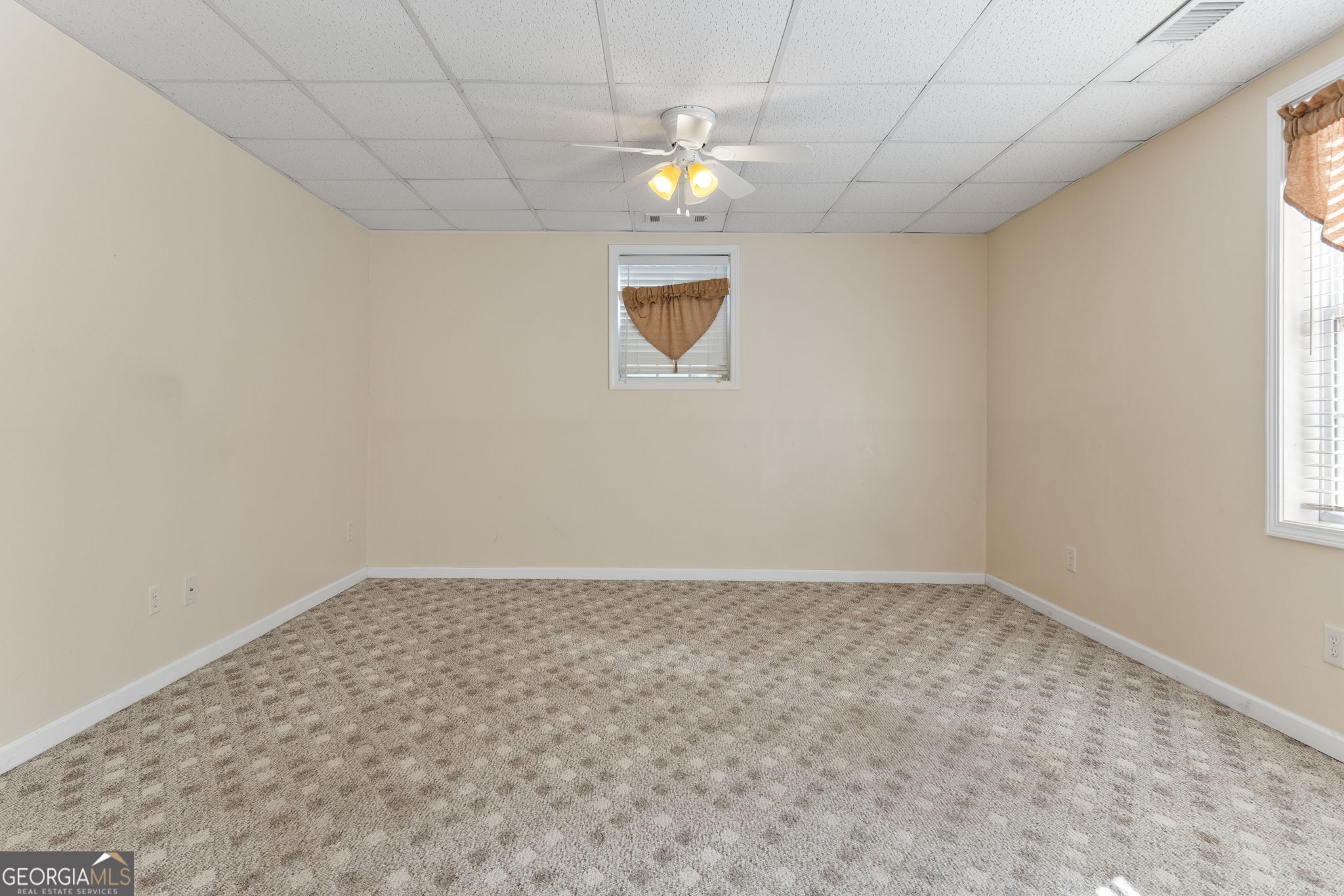400 Moseley Road Stockbridge, GA 30281 - Photo 41 of 70 en empty room with window and chandelier fan