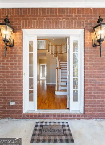 a view of an entryway with wooden floor
