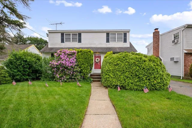 a front view of a house with garden