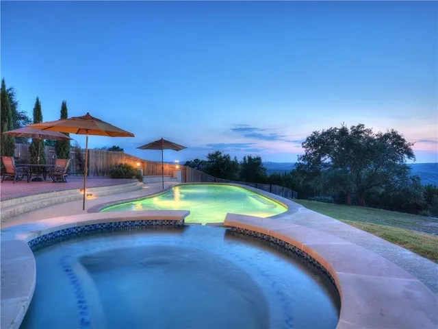 a view of a brick house with potted plants