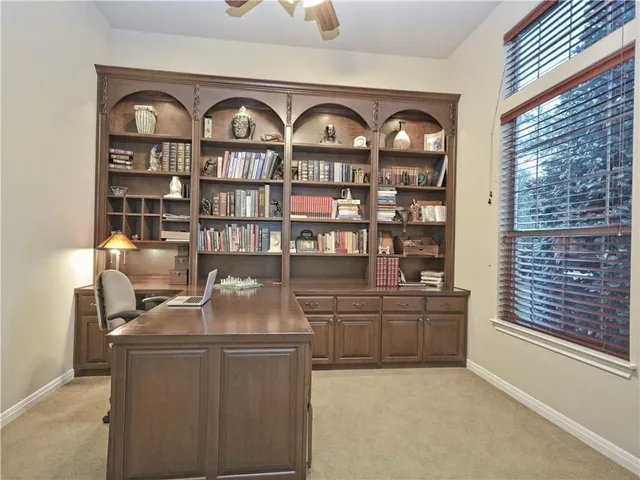 a spacious bedroom with a bed couch and window