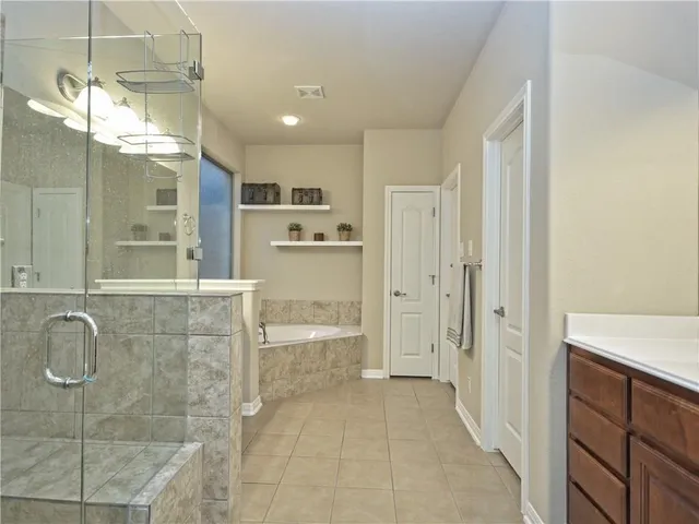 a bathroom with a sink double vanity and a bathtub