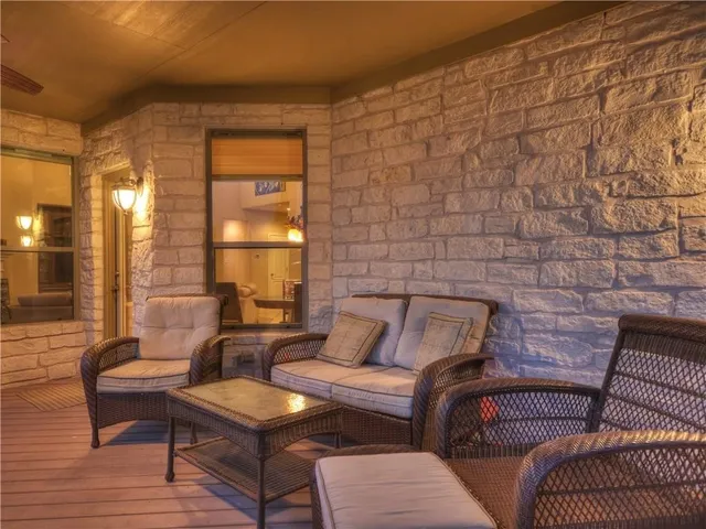 a balcony with wooden floor outdoor seating and city view