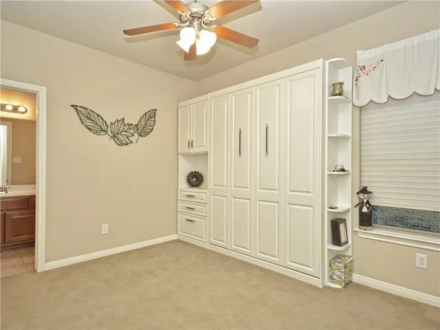 a room with pool table and windows