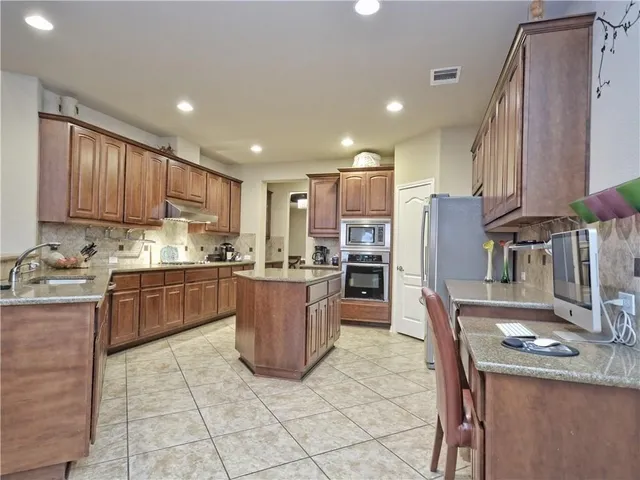 a living room with furniture a fireplace and a large window