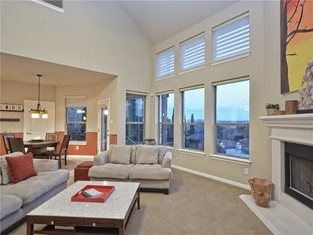 a living room with furniture a fireplace and a chandelier
