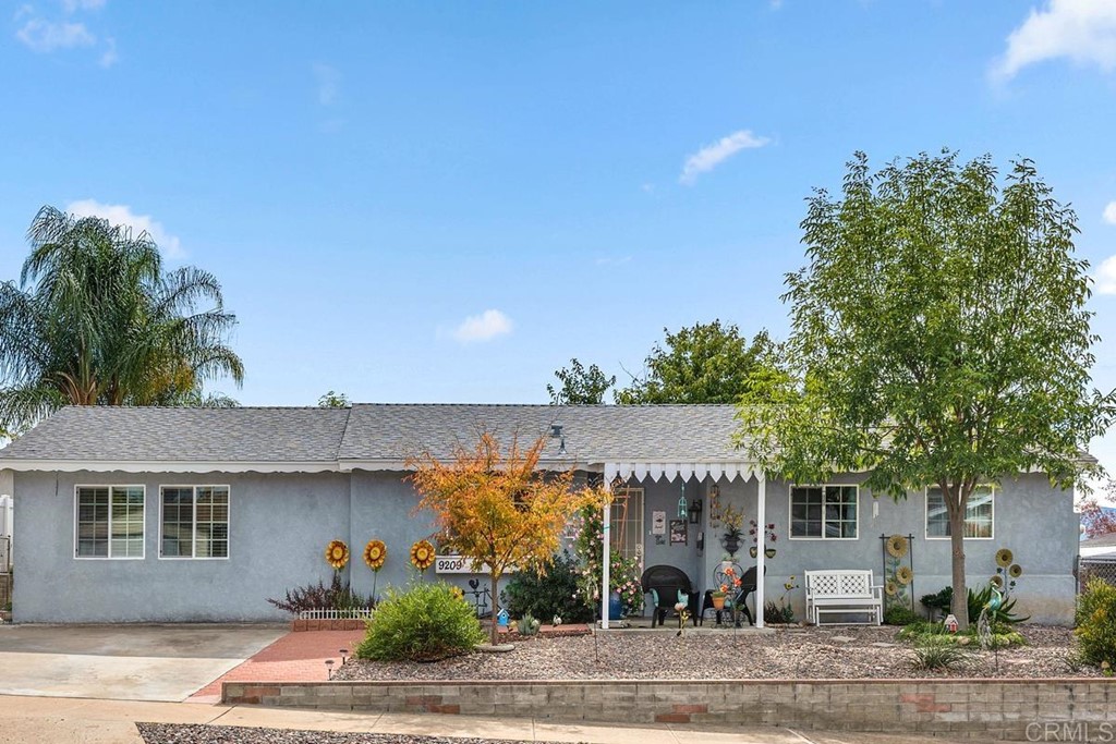 9209 Fenway Road Santee, CA 92071 - Photo 1 of 1 front view of a house with a garden