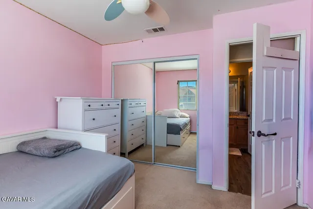 a bedroom with a bed and a dresser