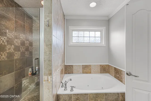 a bathroom with a tub and shower