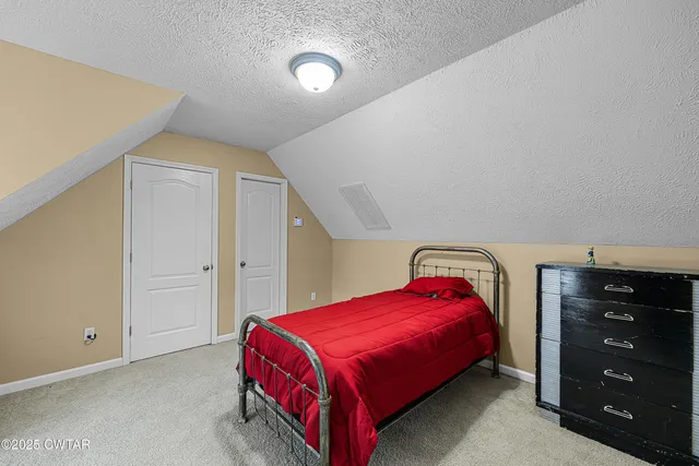 a bedroom with a bed and a closet