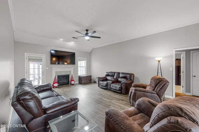 a living room with furniture fireplace and a flat screen tv
