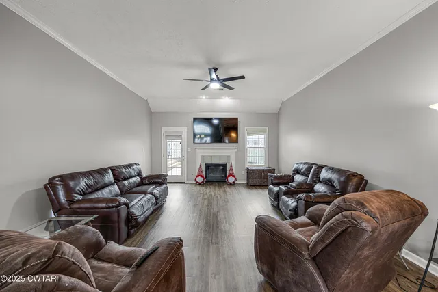 a living room with furniture ceiling fan and a rug