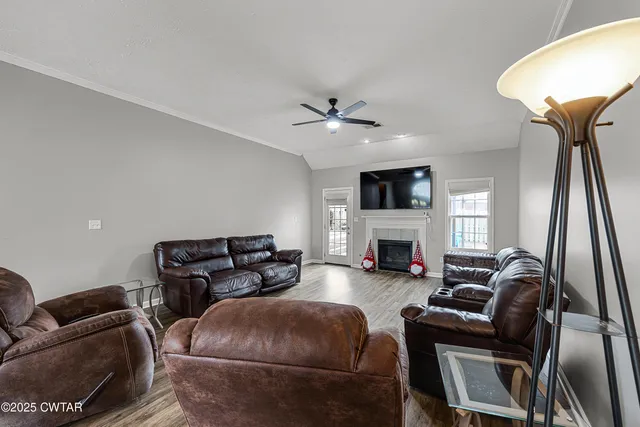 a living room with furniture a fireplace and a flat screen tv