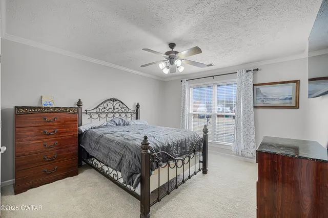 a bedroom with a bed a chandelier and closet