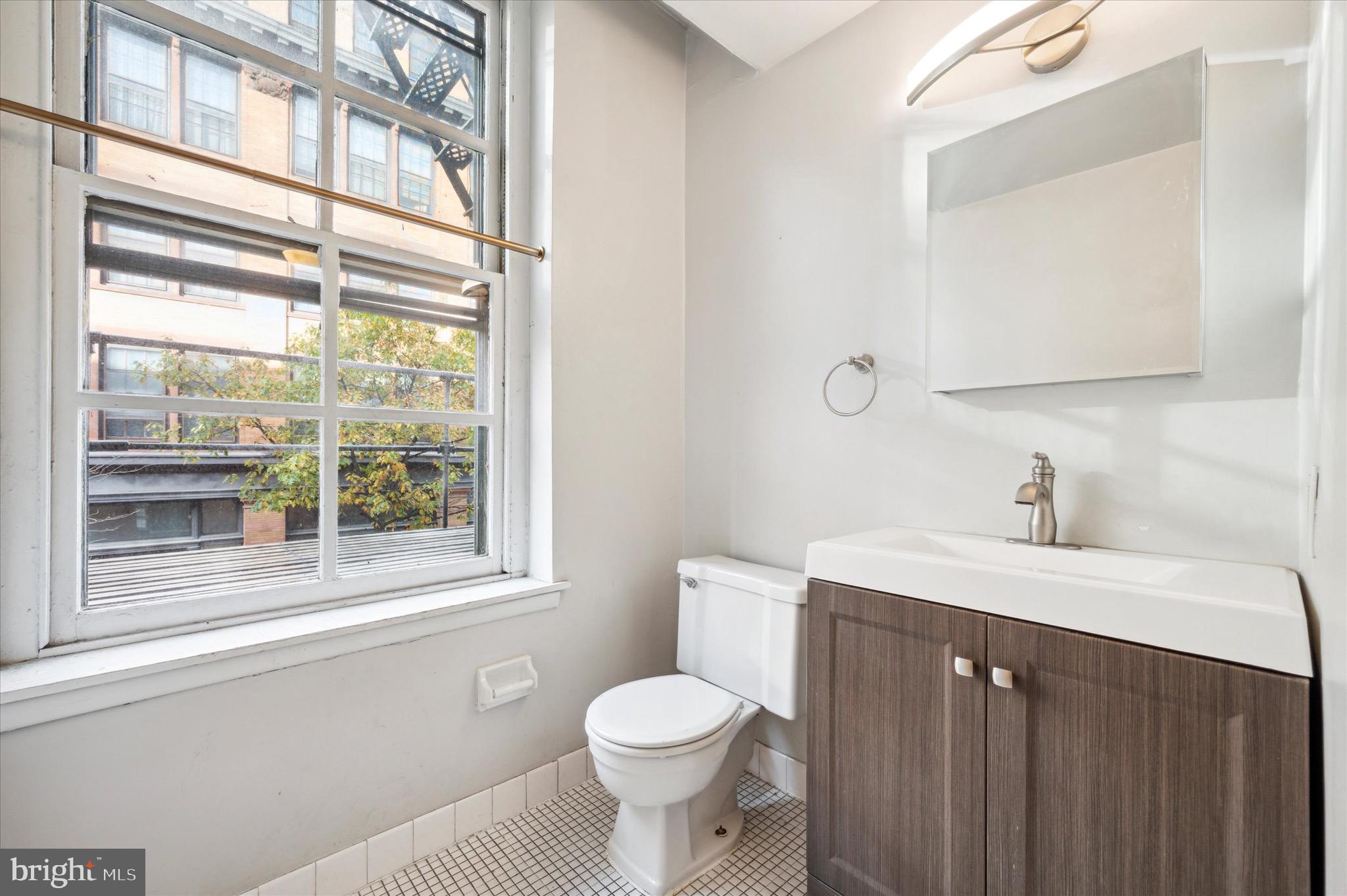 162 North 3rd Street, Unit 2 Philadelphia, PA 19106 - Photo 12 of 17 a bathroom with a sink a toilet and a window