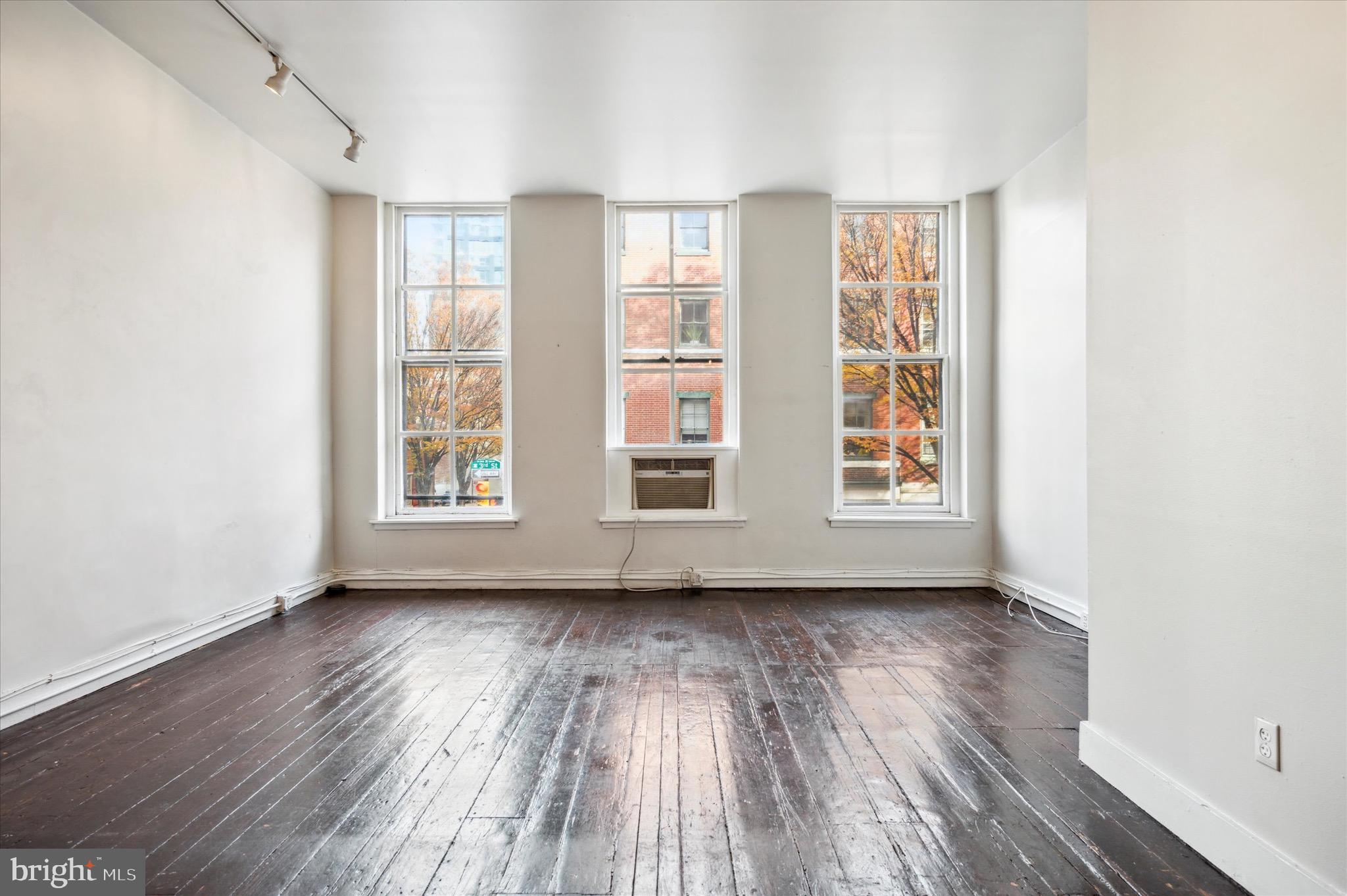 162 North 3rd Street, Unit 2 Philadelphia, PA 19106 - Photo 3 of 17 an empty room with wooden floor and windows