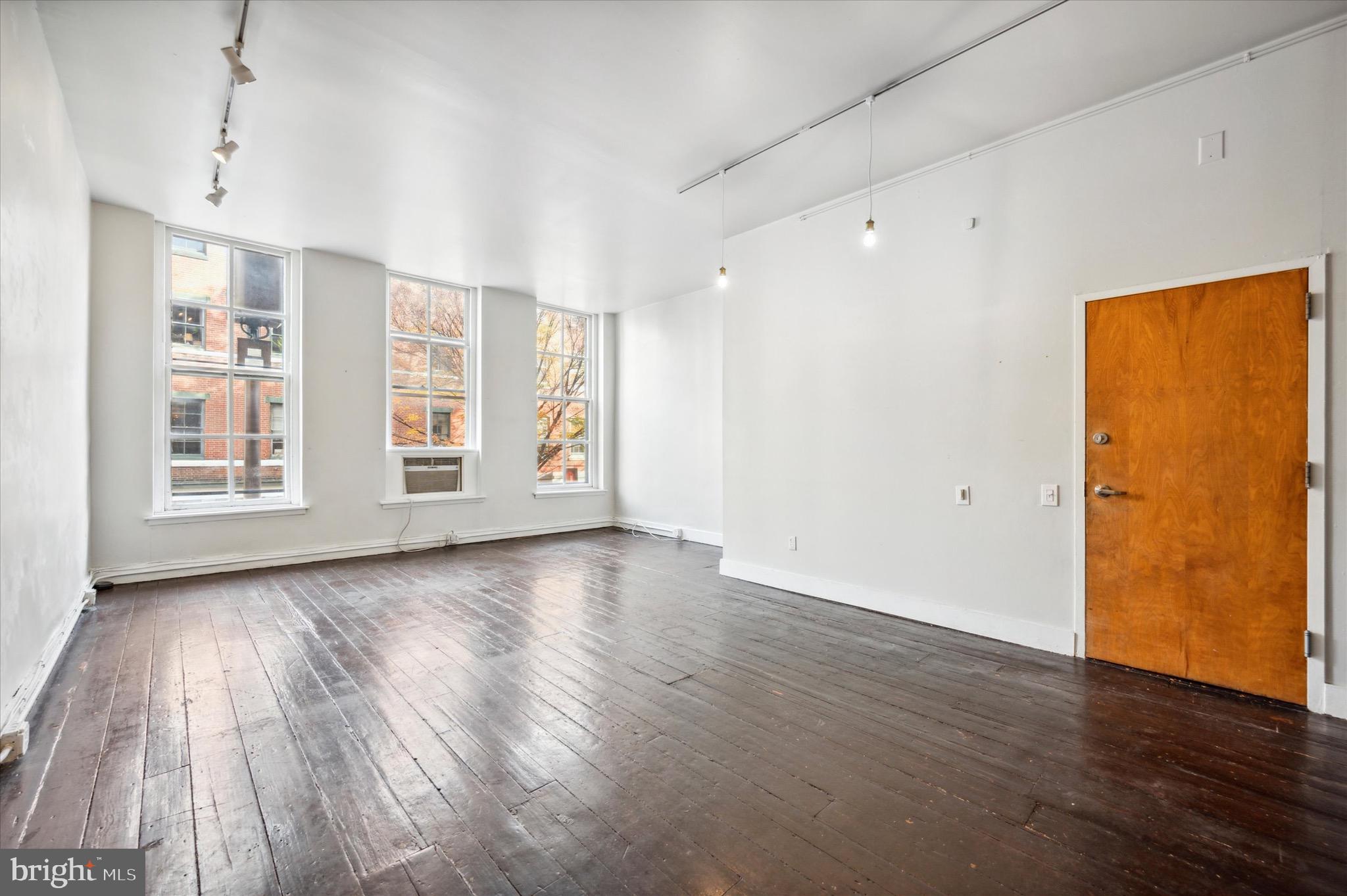 162 North 3rd Street, Unit 2 Philadelphia, PA 19106 - Photo 4 of 17 an empty room with wooden floor and windows