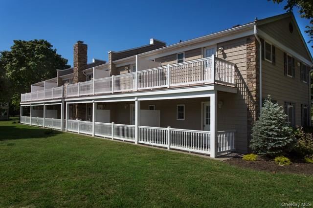 184 Hallock Road, Unit 1A1 Lake Grove, NY 11755 - Photo 2 of 3 a front view of a house with a yard