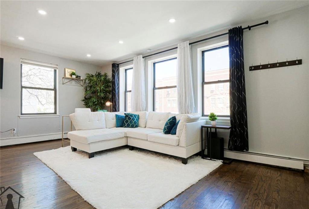 54 Erasmus Street, Unit 2D Brooklyn, NY 11226 - Photo 2 of 7 a living room with furniture and windows