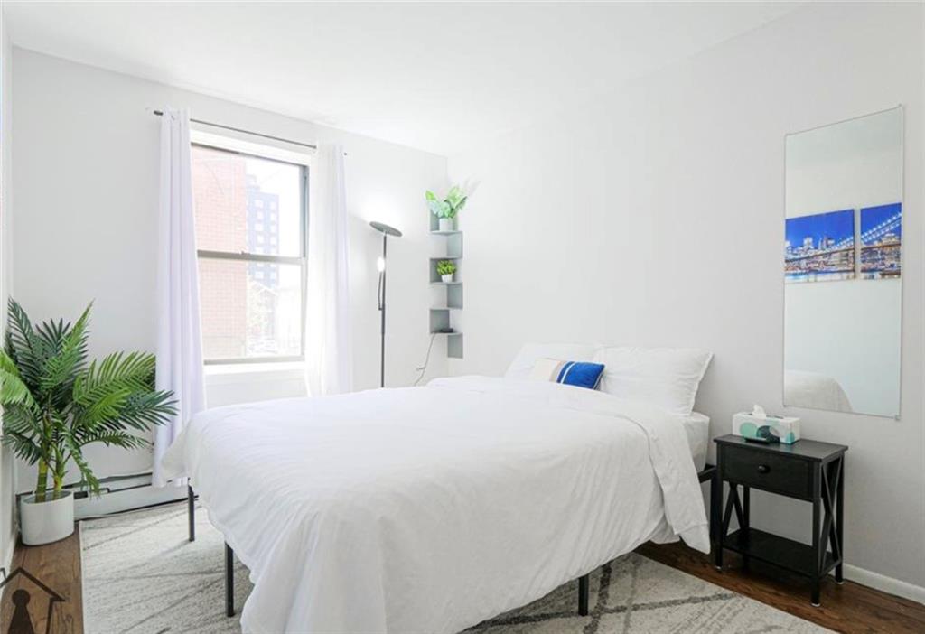 54 Erasmus Street, Unit 2D Brooklyn, NY 11226 - Photo 7 of 7 a bedroom with a bed table chair and a window