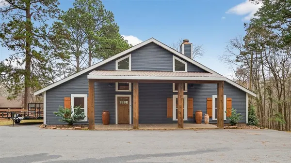 a front view of a house with a tree
