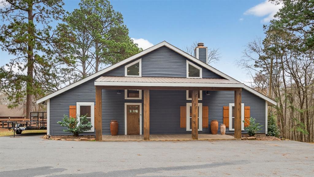 a front view of a house with a tree
