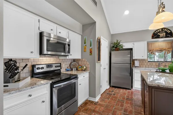 a kitchen with a refrigerator stove and microwave