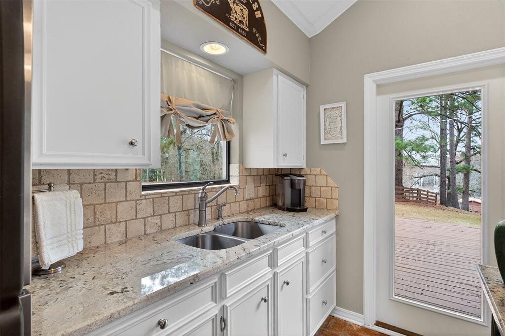 504 Moore Road Elm Grove, LA 71051 - Photo 17 of 37 a kitchen with stainless steel appliances granite countertop a sink stove and cabinets