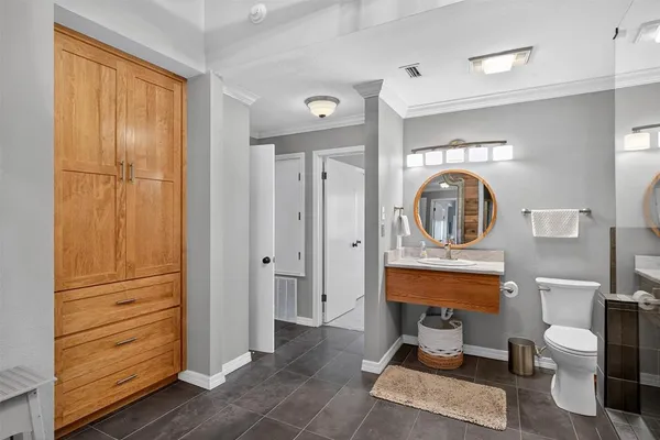 a room with furniture a mirror and clock on the wall