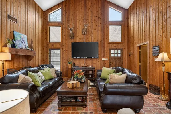 a living room with furniture fireplace and a flat screen tv