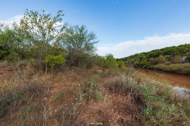 a view of a lake with houses in the back