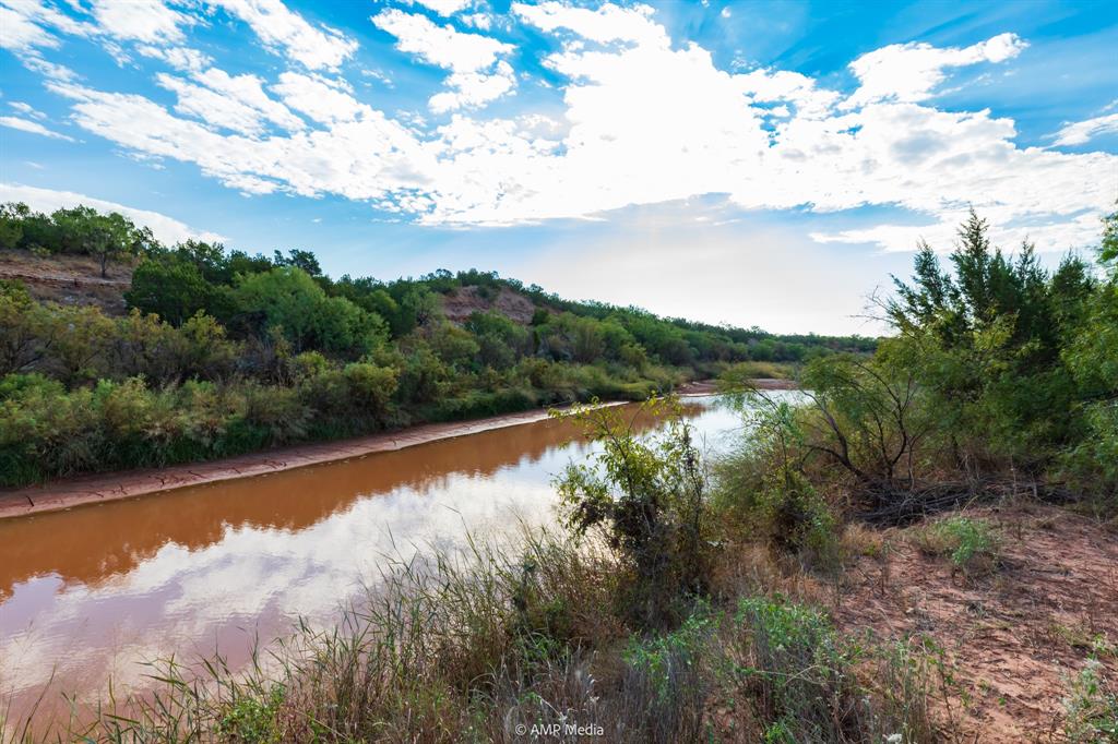 107 C R 107 Aspermont, TX 79502 - Photo 32 of 40 a view of a lake with houses in the back