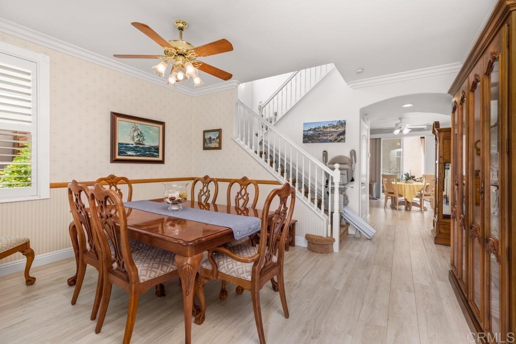 7301 Seafarer Place Carlsbad, CA 92011 - Photo 12 of 33 a dining room with furniture and wooden floor