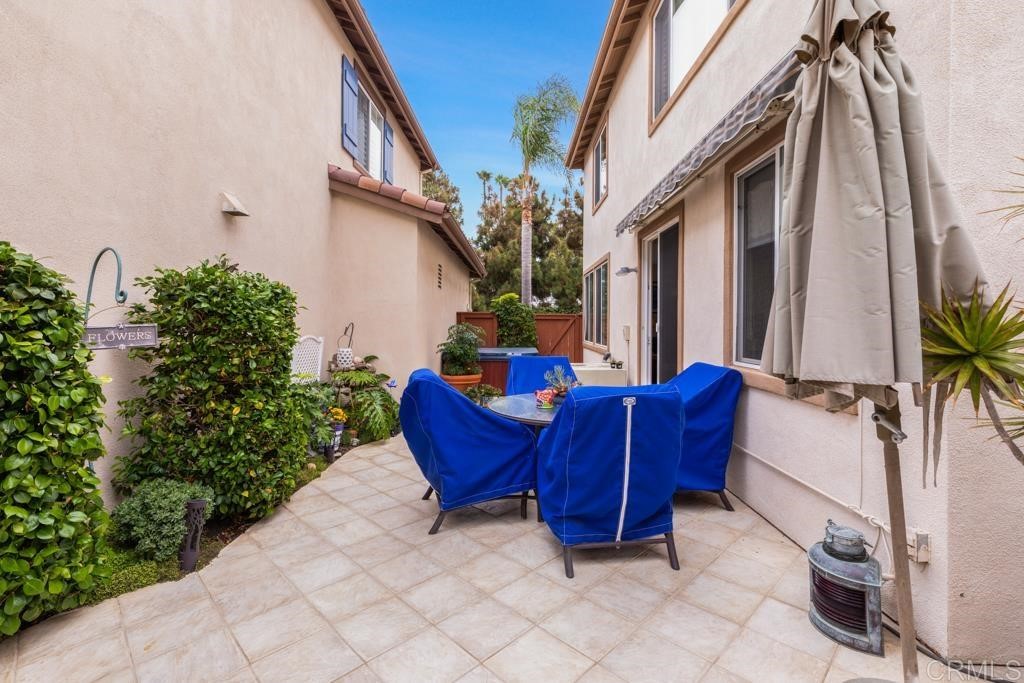 7301 Seafarer Place Carlsbad, CA 92011 - Photo 24 of 33 a view of a chairs with a potted plant in front of a house