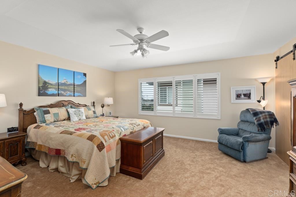 7301 Seafarer Place Carlsbad, CA 92011 - Photo 26 of 33 a spacious bedroom with a bed and a couch
