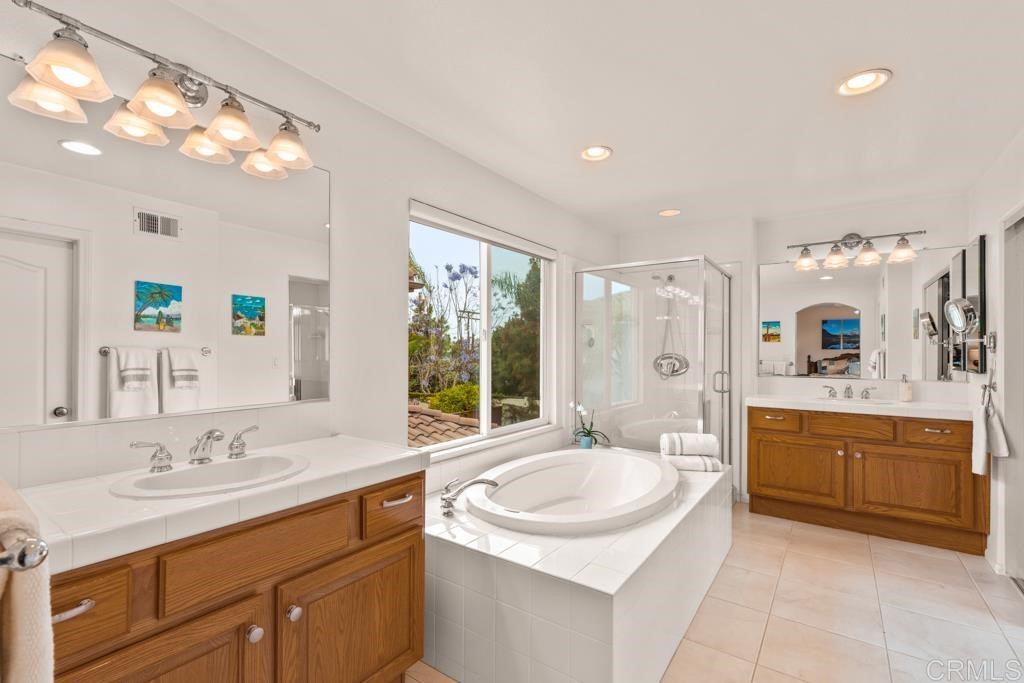 7301 Seafarer Place Carlsbad, CA 92011 - Photo 28 of 33 a bathroom with a granite countertop sink mirror and bathtub