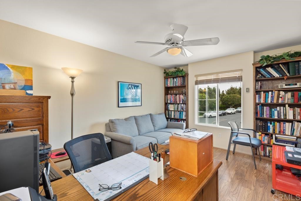 7301 Seafarer Place Carlsbad, CA 92011 - Photo 31 of 33 a living room with furniture a bookshelf and a window