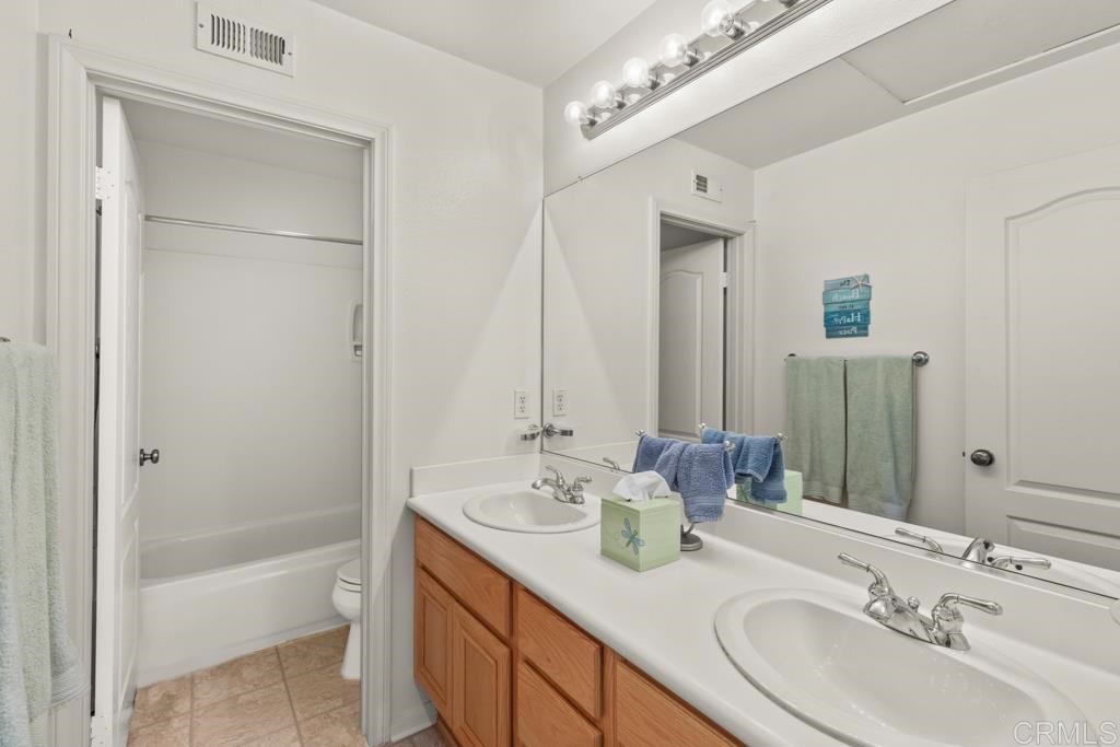 7301 Seafarer Place Carlsbad, CA 92011 - Photo 33 of 33 a bathroom with a double vanity sink mirror and bathtub
