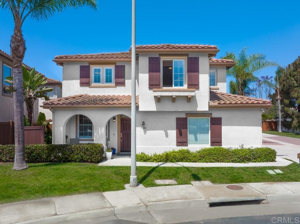 7301 Seafarer Place Carlsbad, CA 92011 - Photo 10 of 33 a front view of a house with a yard and garage
