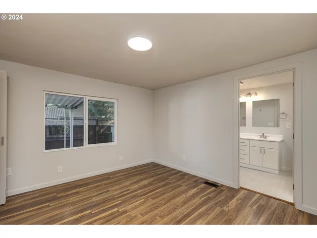 a view of wooden floor and windows in a room