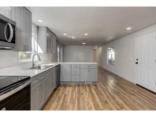 a kitchen with a sink stove and cabinets