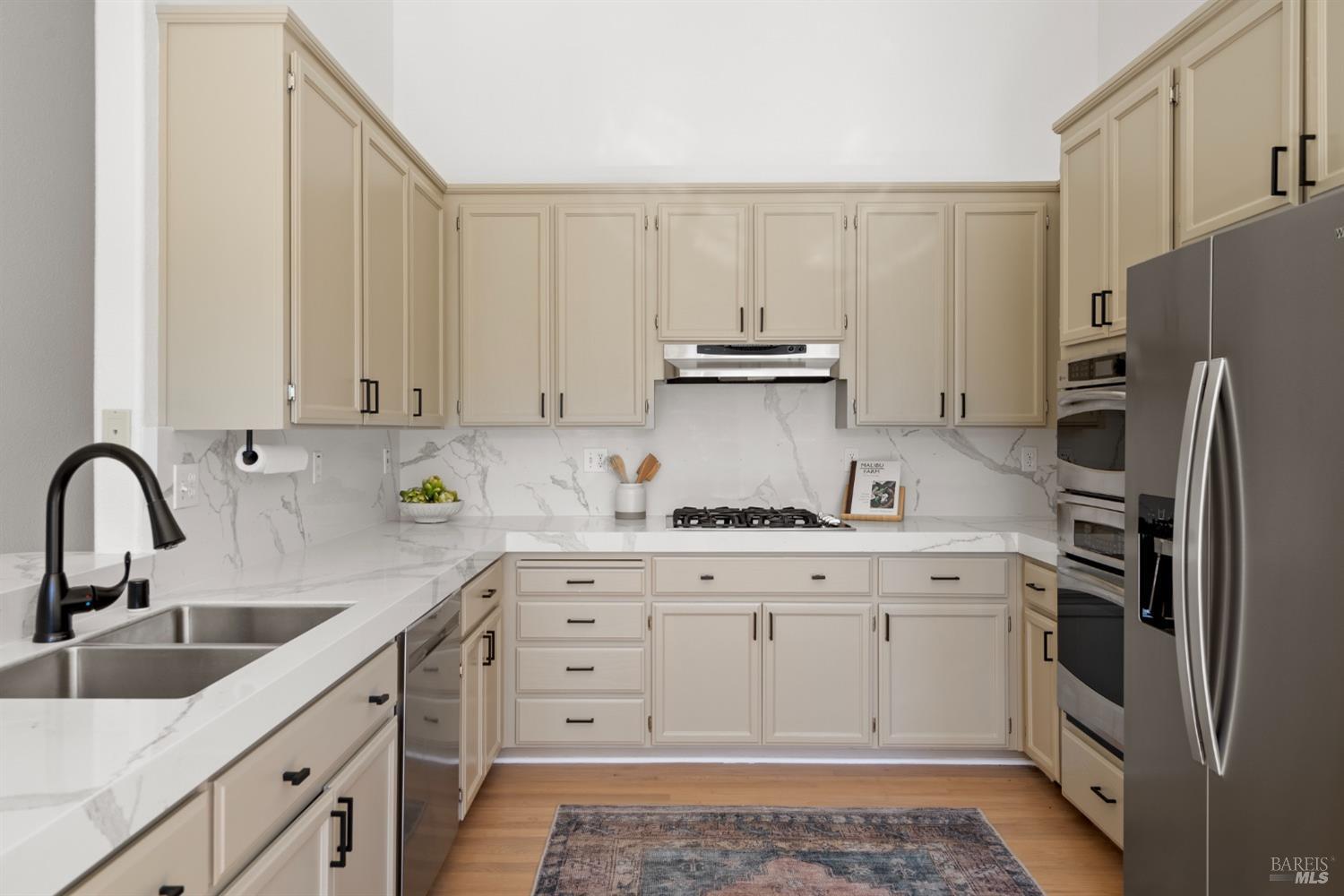 8 Pacific Drive Novato, CA 94949 - Photo 11 of 37 a kitchen with stainless steel appliances granite countertop a sink stove and refrigerator