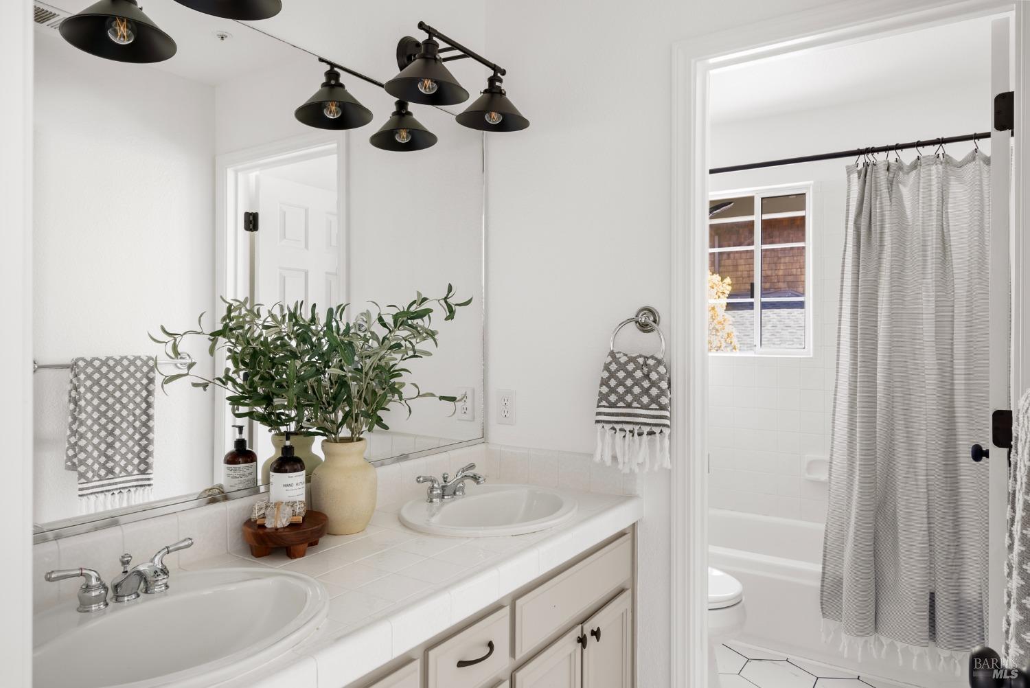 8 Pacific Drive Novato, CA 94949 - Photo 29 of 37 a bathroom with a sink and a mirror