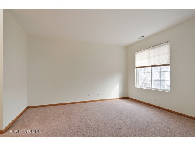 840 County Line Road Aurora, IL 60502 - Photo 7 of 10 an empty room with wooden floor and windows