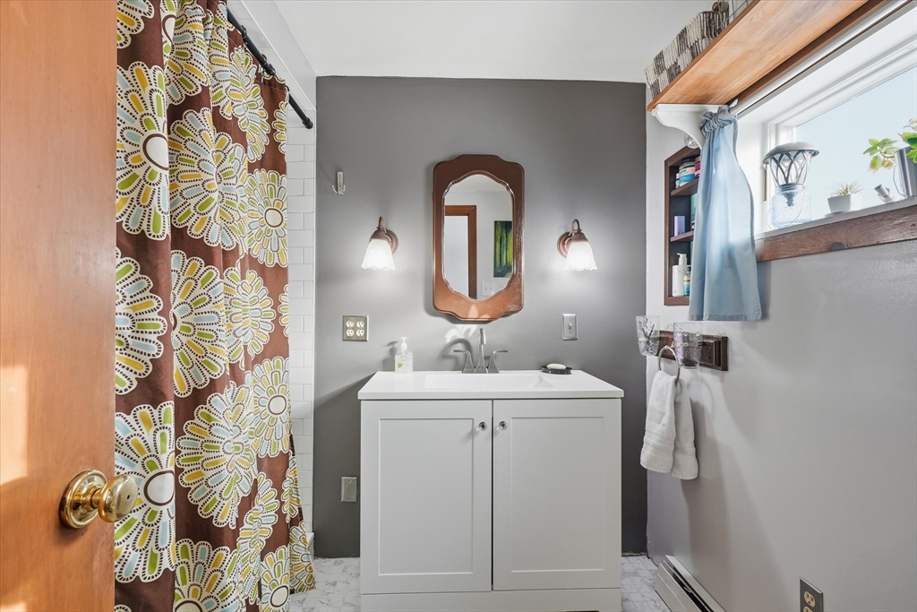59 Fay Street Lowell, MA 01852 - Photo 16 of 33 a bathroom with a sink and mirror with shower