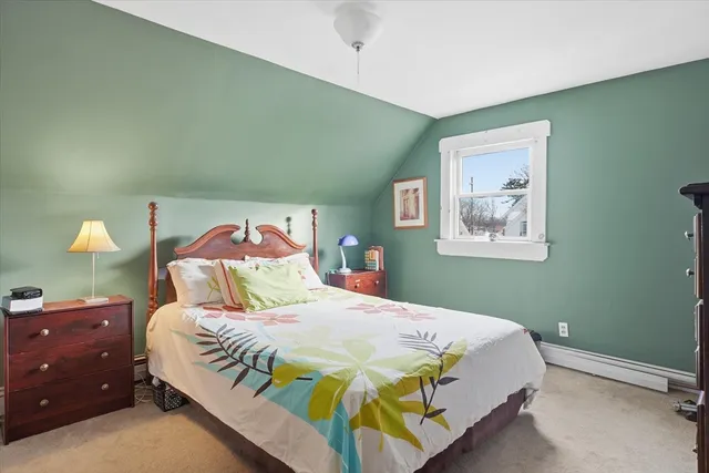 a bedroom with a bed and lamp with window