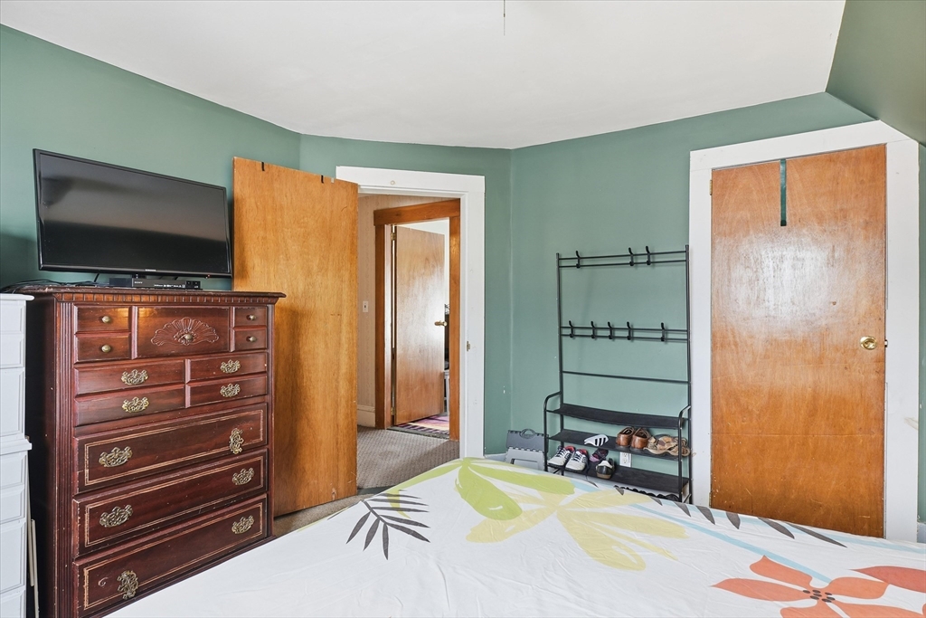 59 Fay Street Lowell, MA 01852 - Photo 22 of 33 a bedroom with furniture and a flat screen tv